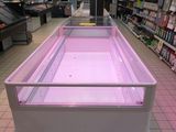 a pink display case in the middle of a grocery store