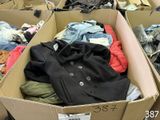 a cardboard box filled with clothes and clothing items