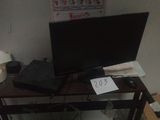 a computer desk with a monitor and a laptop on it
