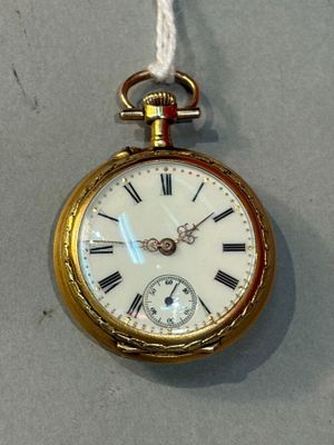 a gold pocket watch with roman numerals hanging from a rope