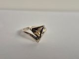 a close up of a silver ring on a white surface