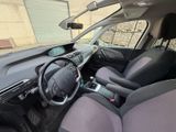 the interior of a small car with a steering wheel and dashboard