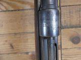 a close up of a gun on a wooden floor