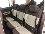 four seats in the back of a car that are black and white