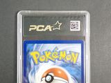 the pokemon card is in a plastic case on a table