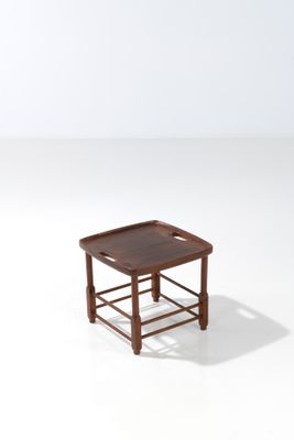 an image of a small wooden table with a tray on top of it