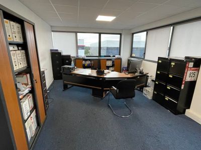 a room with a desk, a chair, and a bookcase