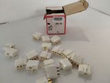 a box of white electrical plugs on a white surface