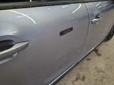 a silver car with a sticker on the side of it
