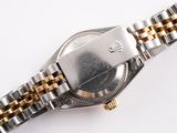 a silver and gold wrist watch on a white surface