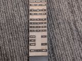a remote control sitting on the carpet on the floor