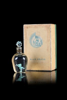 a small bottle of perfume sitting next to a box