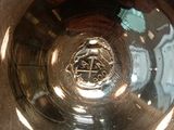 a silver bowl sitting on top of a wooden table