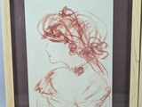 framed drawing of a woman in profile with her hair blowing in the wind