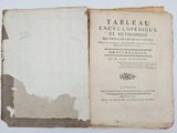 an old book with a black and white cover sitting on top of a table