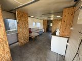 an image of a living room with a lot of plywood walls
