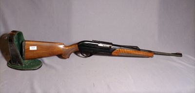 a close up of a rifle on a table with a hat on it