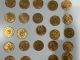a lot of gold coins that are on the table