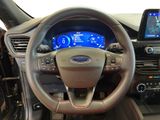 the interior of a car with a steering wheel, dashboard, and display screen