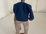 a figurine of a man wearing a hat and holding a suitcase