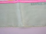 a picture of a pink and green purse with a pink handle