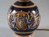 a blue and orange vase with a gold trim around it