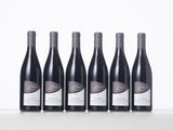 six bottles of wine lined up in a row on a table