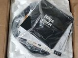 a box with a laptop inside of it that is wrapped in plastic