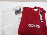 a red adidas shirt and a white adidas t - shirt on a table