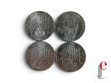 four coins are shown on a white surface with a red and white logo in the middle