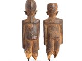 pair of wooden figurines of a man and a woman