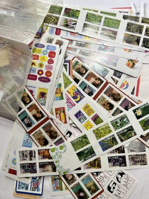 a pile of stamps on a table with a bag of them