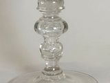 a glass vase with a flower inside of it on a table