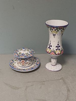 a small vase and a small plate on a table