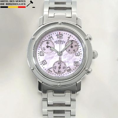 a close up of a watch on a white surface