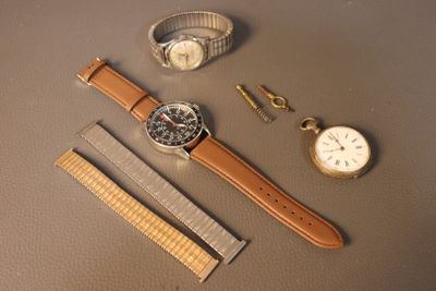 a watch, a watch band, a watch and a watch on a table