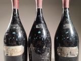 three bottles of wine sitting on top of a table next to each other