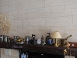many pots and pans on the mantle of this room