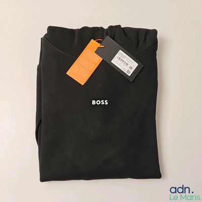 a close up of a black t - shirt with a tag on it