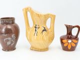 three vases sitting next to each other on a white surface
