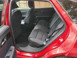 a red car with the door open and the seats down