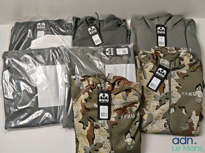many different shirts that are on display on a table