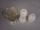 three glass vases sitting next to each other on a table