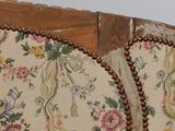 a close up of a chair with a floral pattern on it