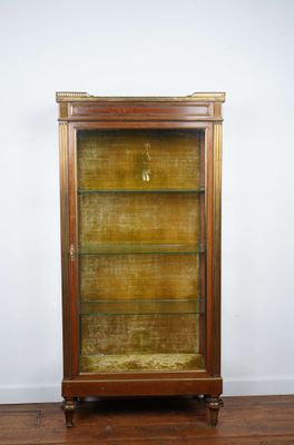 a wooden display case with glass shelves on top of a hard wood floor