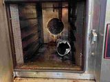 a metal oven with a bunch of food inside of it