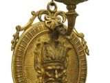 bougeoir plaqué or surmonté d'une tête de lion