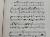 an open book with a page of music written in it