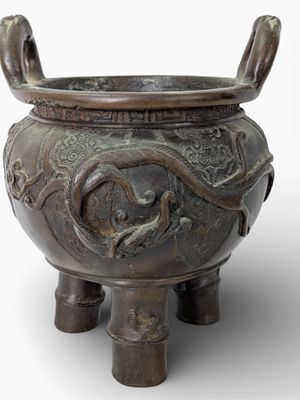 a large bronze pot with a dragon design on it