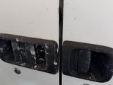 the door of a white van with a blue stripe on the side